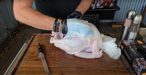 Turkey with loosened skin, prepared for seasoning before cooking