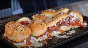 Freshly grilled meatball sliders topped with everything bagel seasoning, served hot and ready to eat.