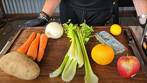 Prepared vegetables including carrots, potatoes, and oranges for turkey stuffing