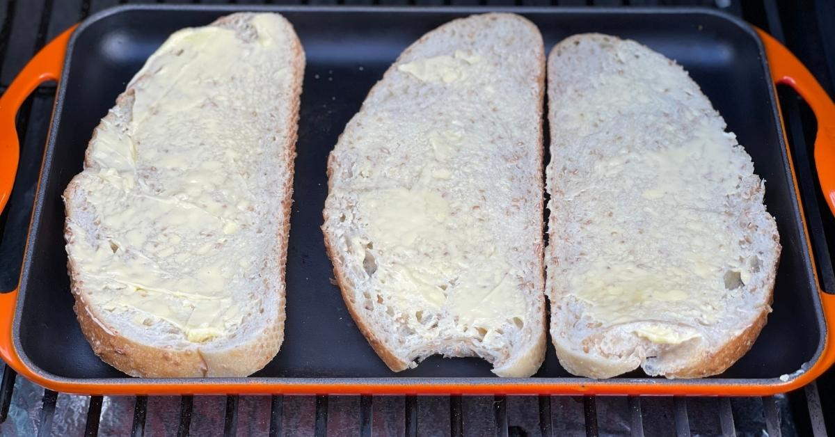 placing the bread on a flat cast iron griddle